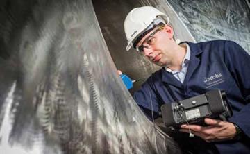 A Jacobs employee inspecting a component at the General Engineering Development Testing Facility at Birchwood Park.